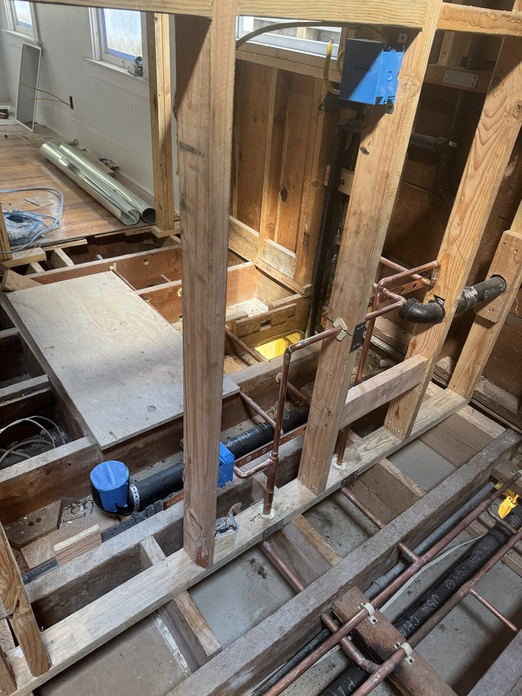 Copper repipe rough-in behind an open wall during a whole-house repiping project in Concord, CA