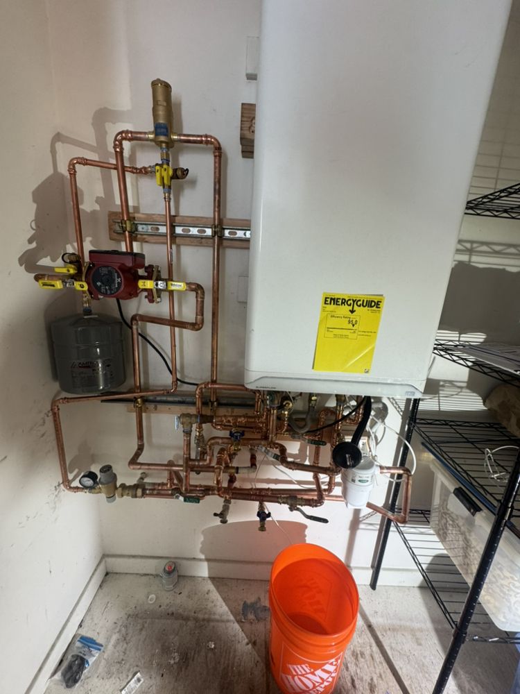 Professionally installed copper plumbing manifold and tankless water heater by 5 Star Plumbing & Sewer